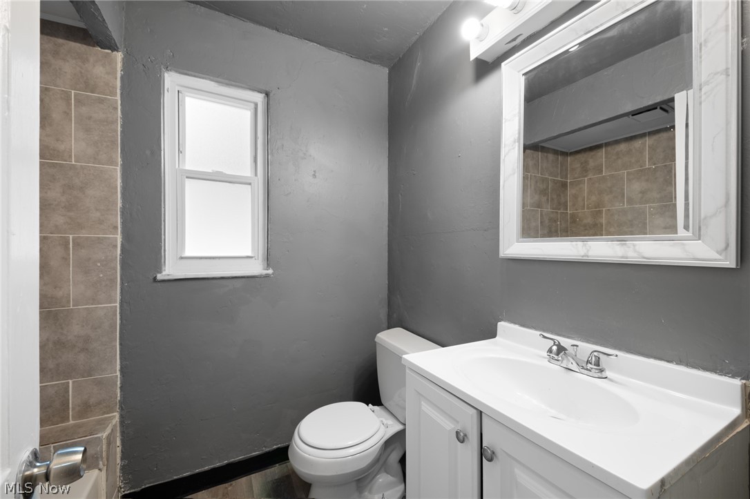 4122 Lambert Road Cleveland, OH 44121 - Photo 15 of 32 Bathroom with vanity, toilet, and hardwood / wood-style flooring