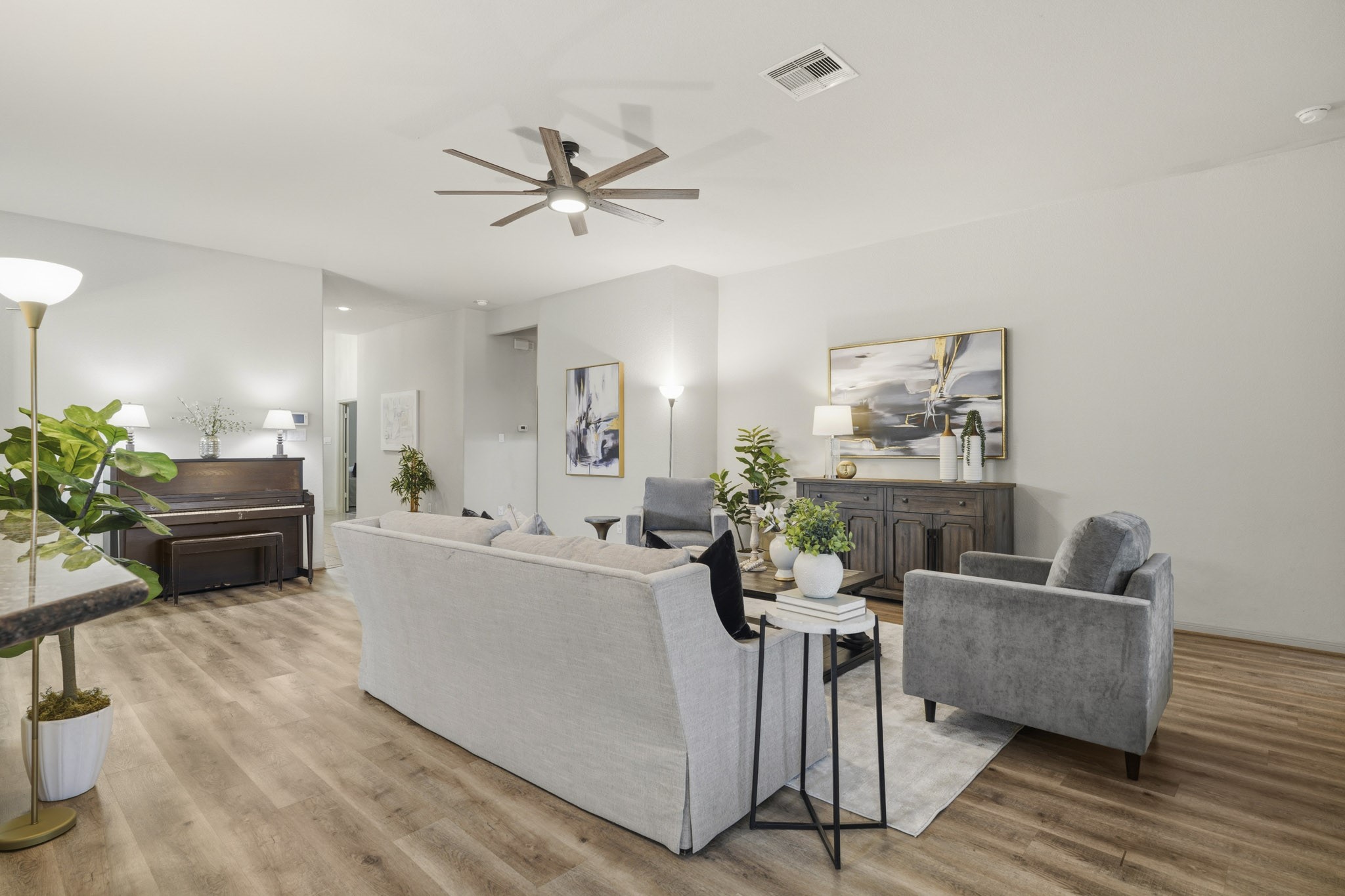 2502 Tiger Eye Drive Rosharon, TX 77583 - Photo 8 of 40 Modern, updated ceiling fan and low-maintenance LVP flooring are highlights of the spacious living room.