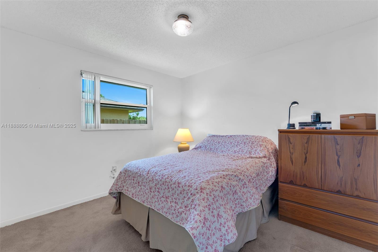 11614 Southwest 101st Terrace Miami, FL 33176 - Photo 12 of 17 a bedroom with a bed and dresser