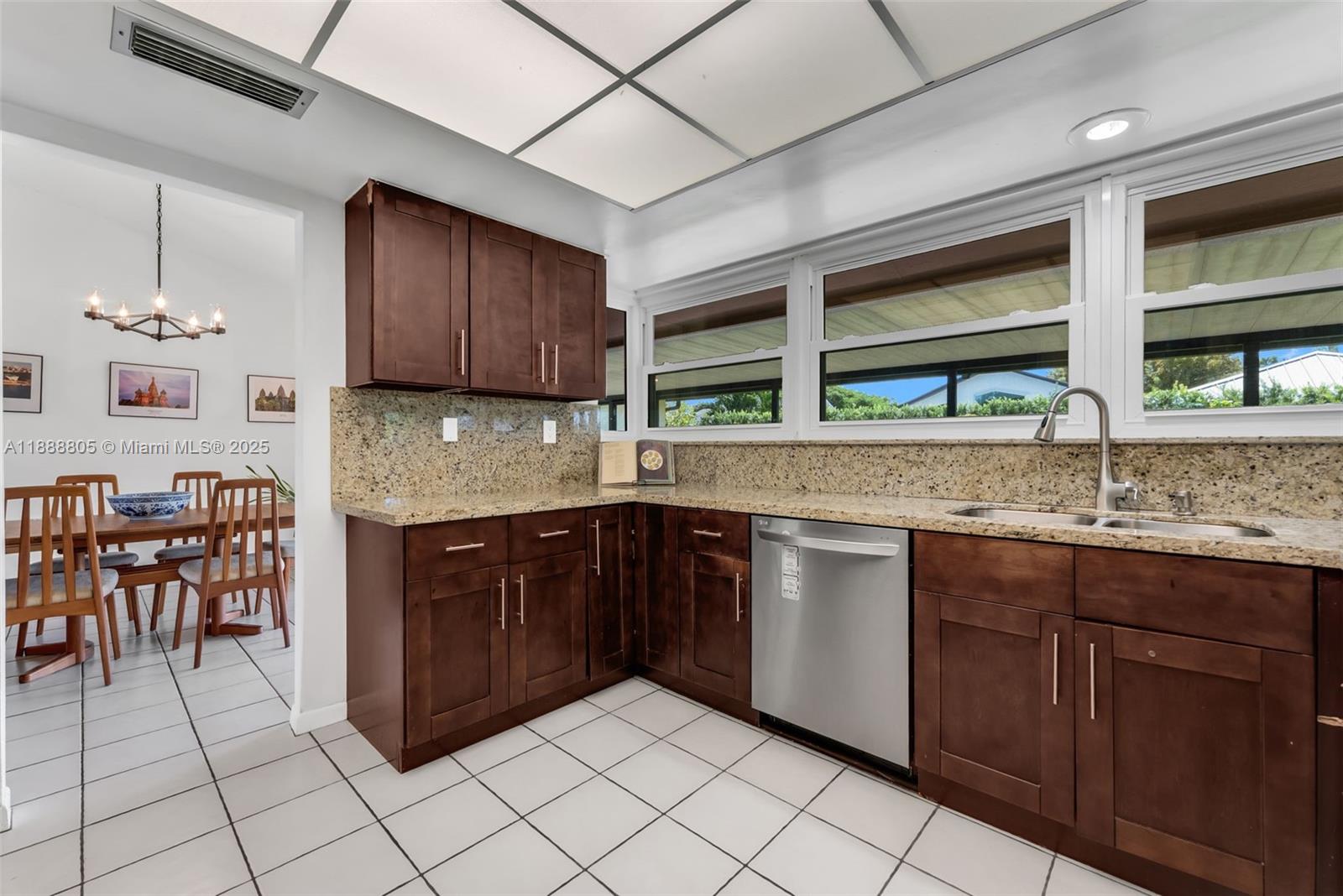 11614 Southwest 101st Terrace Miami, FL 33176 - Photo 6 of 17 a kitchen with a sink window and cabinets