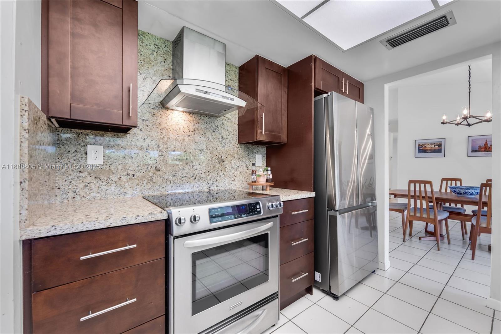 11614 Southwest 101st Terrace Miami, FL 33176 - Photo 7 of 17 a kitchen with stainless steel appliances granite countertop a stove a refrigerator and a microwave