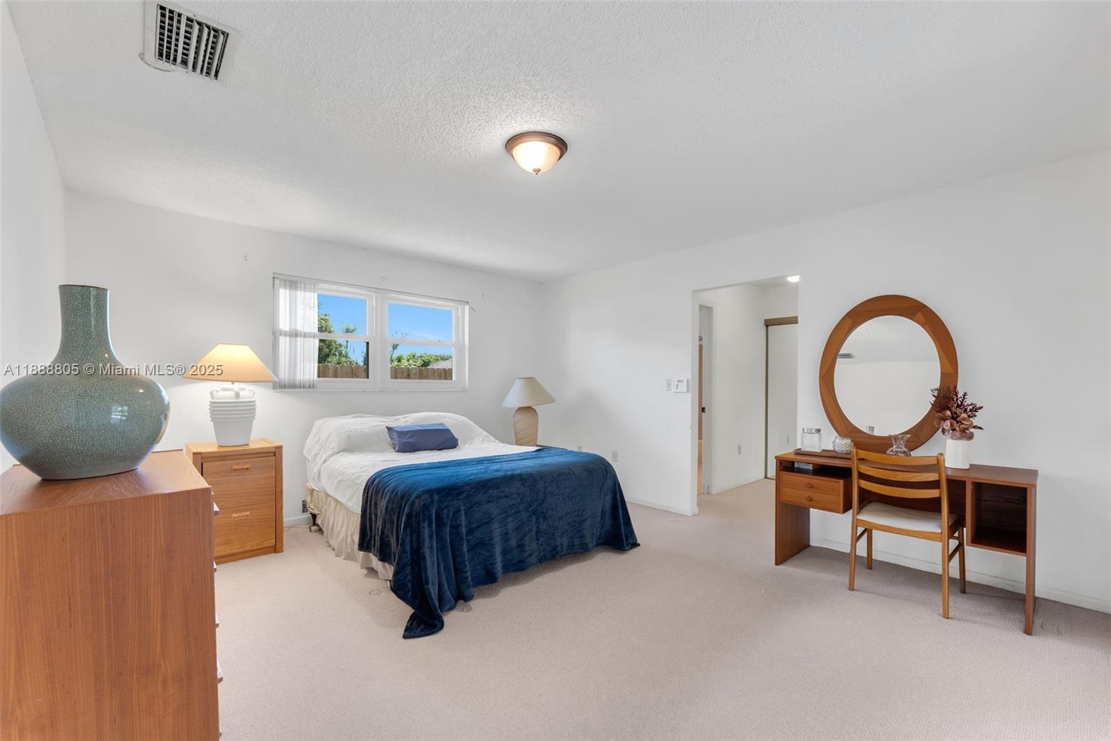 11614 Southwest 101st Terrace Miami, FL 33176 - Photo 10 of 17 a bedroom with a bed and a chandelier