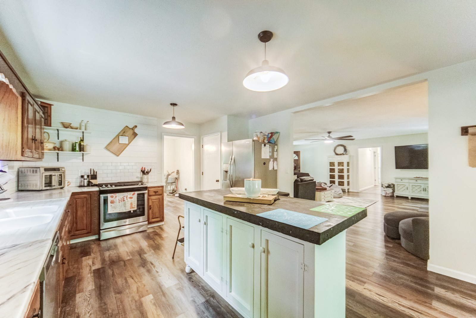 3733 Oakland Road Springfield, TN 37172 - Photo 9 of 43 a large kitchen with kitchen island a large counter space a sink appliances and living room view
