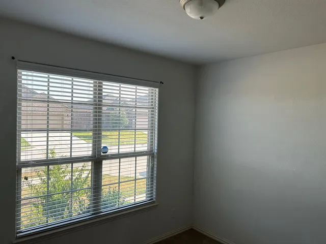 a view of a backyard with a barbeque grill and wooden fence