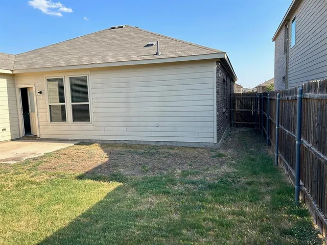 a view of a backyard of the house