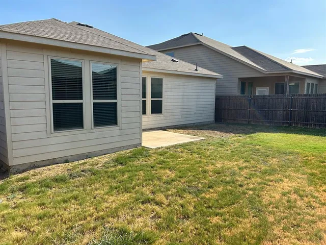 a house view with a backyard space