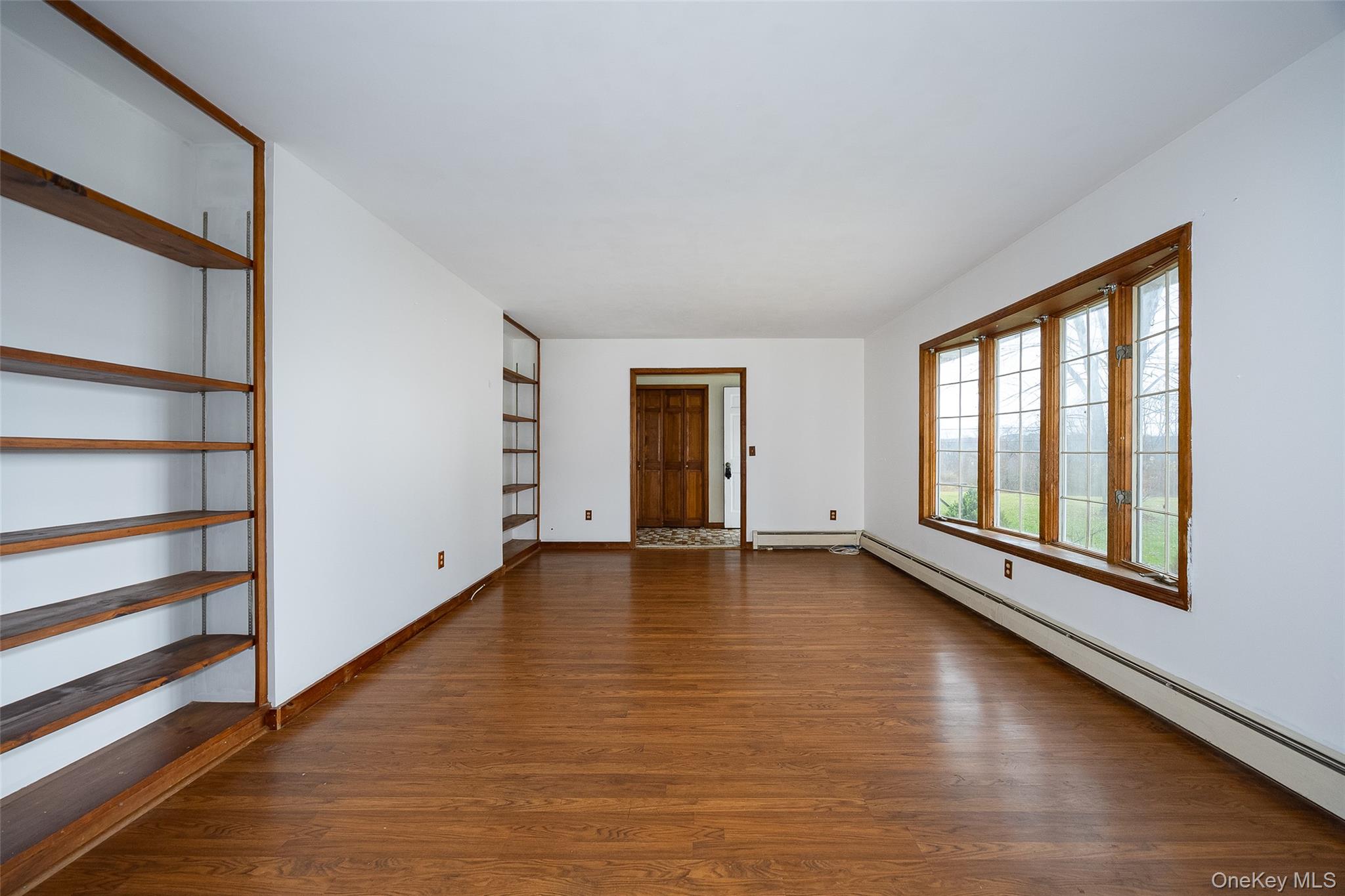 1 Peach Road Poughkeepsie, NY 12601 - Photo 6 of 22 a view of an empty room with a window and wooden floor