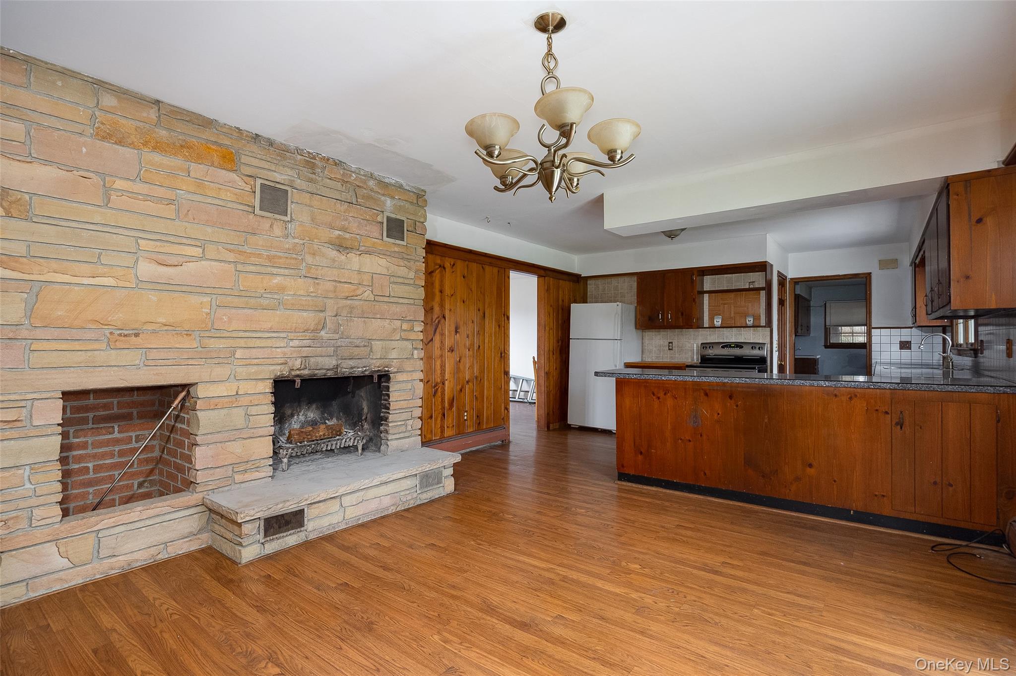 1 Peach Road Poughkeepsie, NY 12601 - Photo 9 of 22 a living room with stainless steel appliances kitchen island granite countertop furniture and a fireplace
