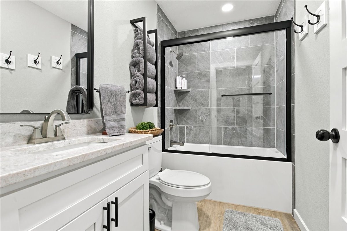 12 Hoot Loop Cartwright, OK 74731 - Photo 19 of 35 White vanity with black hardware, light-toned countertop, and undermount sink