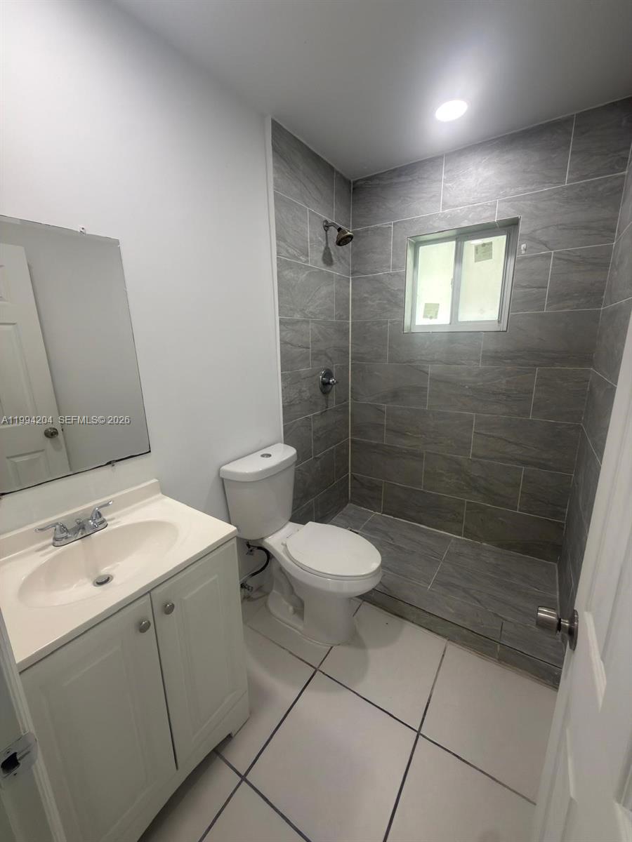 2622 Northwest 24th Street, Unit 1B Miami, FL 33142 - Photo 14 of 16 a bathroom with a toilet sink and shower