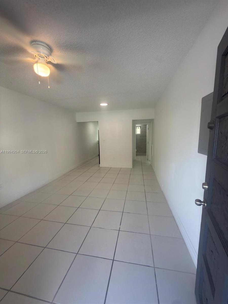 2622 Northwest 24th Street, Unit 1B Miami, FL 33142 - Photo 3 of 16 a view of an empty room with a mirror