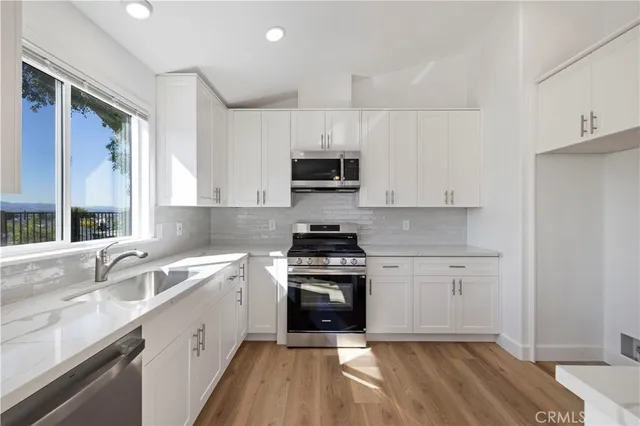 a kitchen with a sink stove and cabinets