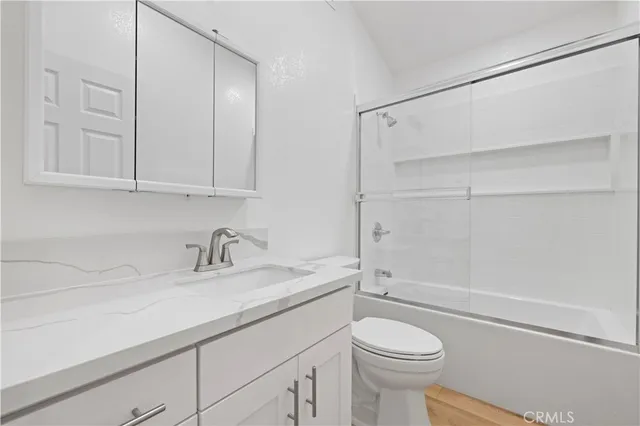 a bathroom with a sink a toilet and vanity