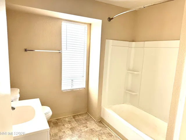 a bathroom with a bathtub and shower
