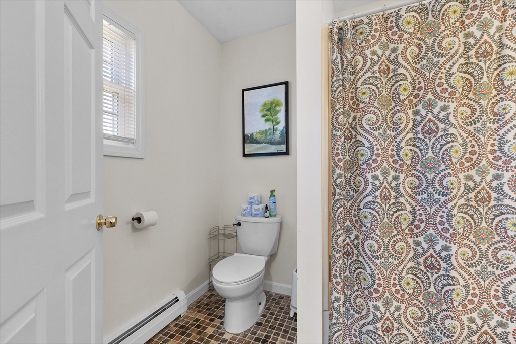 38 Brook Street Georgetown, MA 01833 - Photo 17 of 42 a bathroom with a toilet and a shower curtain