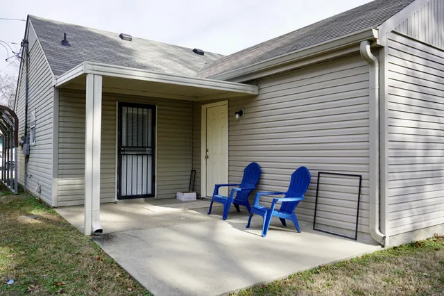 a view of a two chairs in front of house