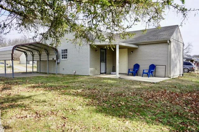 a view of a house with a yard and garage