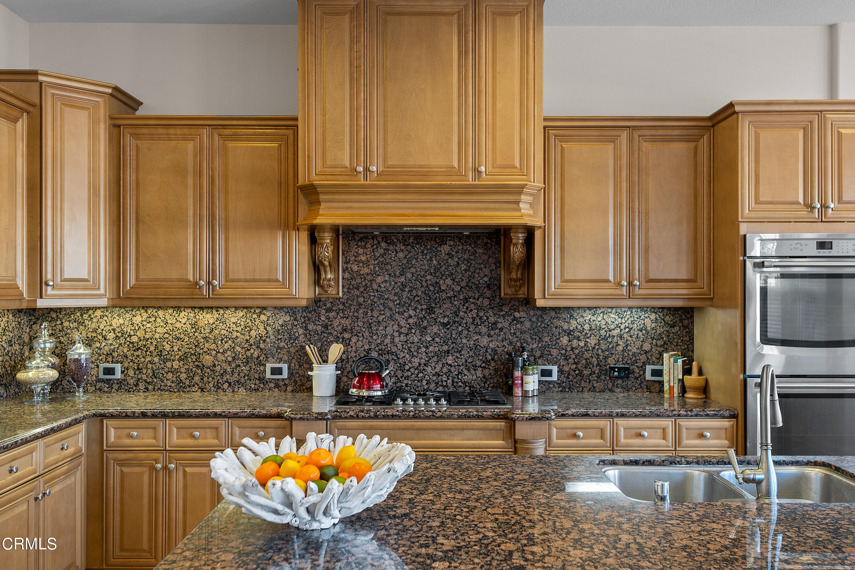 3957 West Hemlock Street Oxnard, CA 93035 - Photo 21 of 46 a kitchen with granite countertop a sink a stove and cabinets