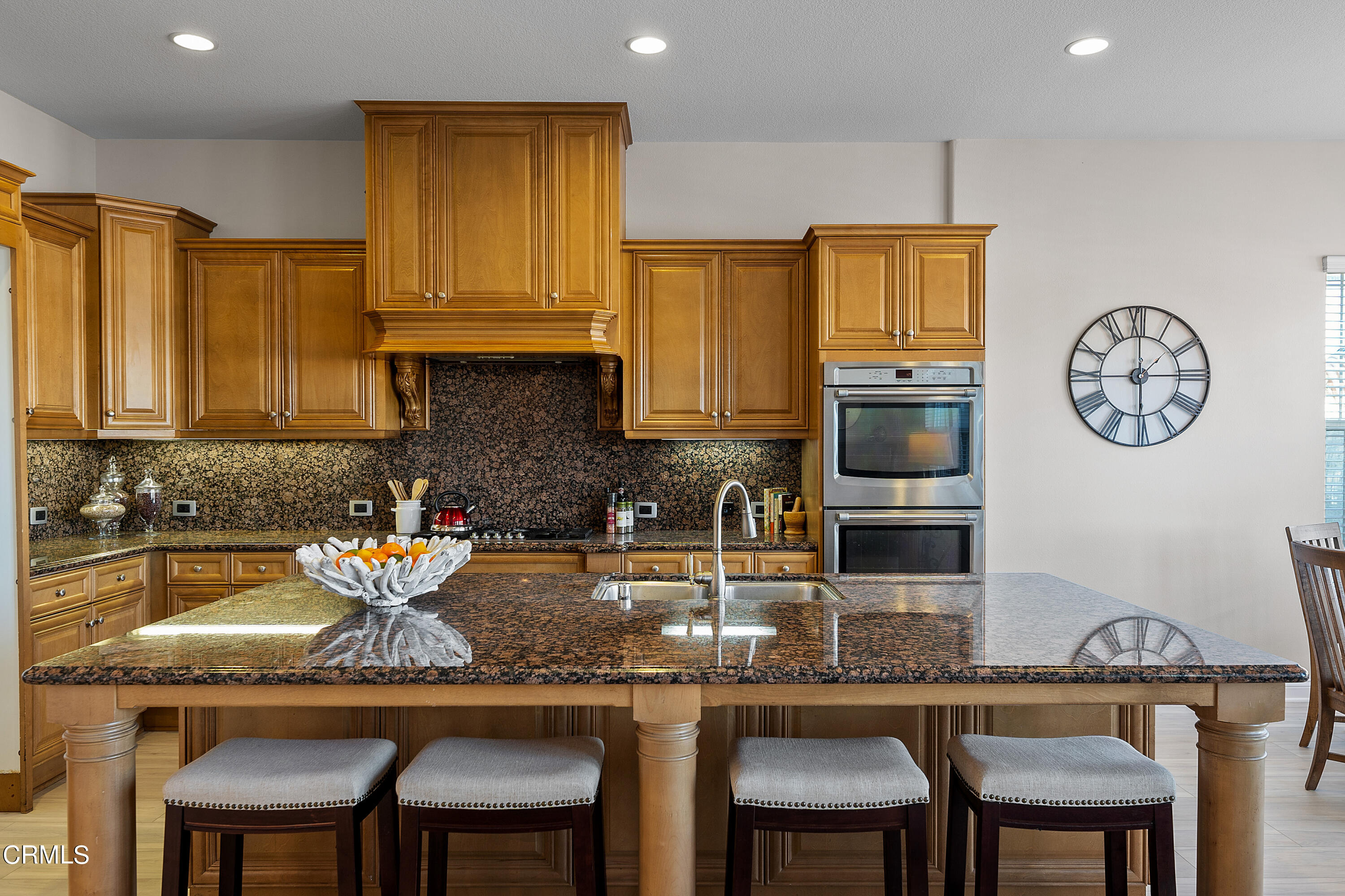 3957 West Hemlock Street Oxnard, CA 93035 - Photo 23 of 46 a kitchen with stainless steel appliances granite countertop a table chairs refrigerator and sink