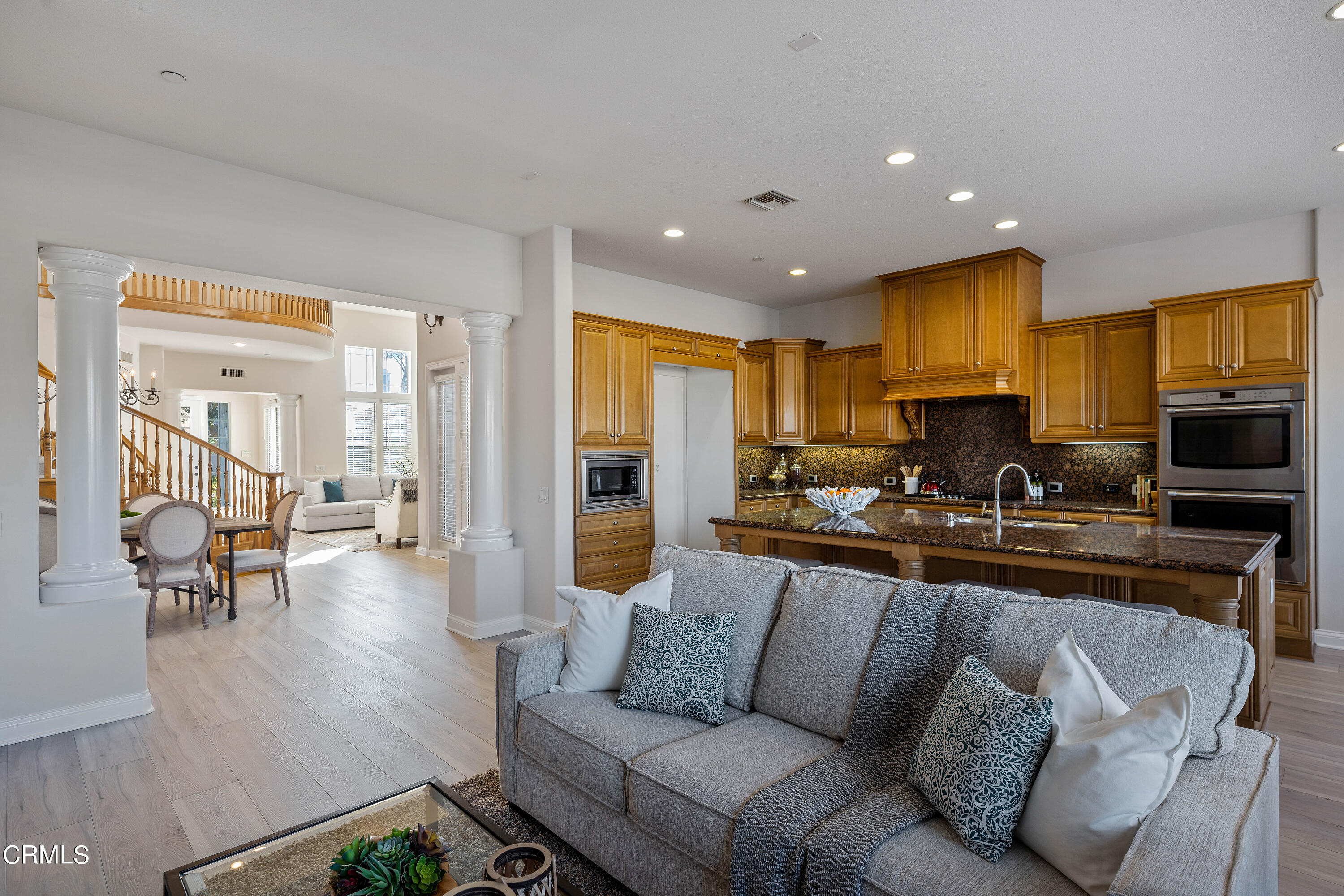 3957 West Hemlock Street Oxnard, CA 93035 - Photo 26 of 46 a living room with furniture wooden floor and a kitchen view