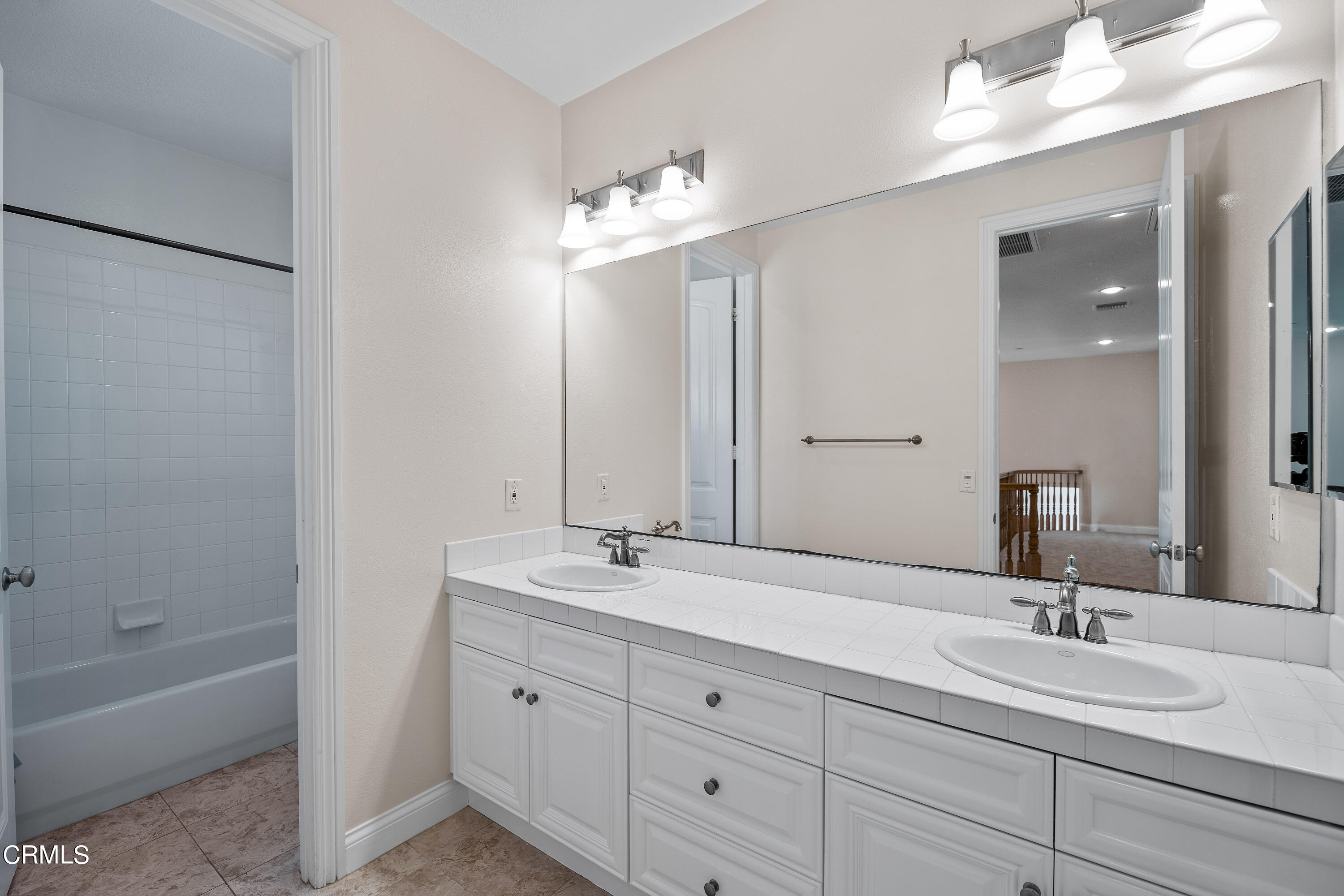 3957 West Hemlock Street Oxnard, CA 93035 - Photo 34 of 46 a bathroom with double vanity sinks and a bathtub