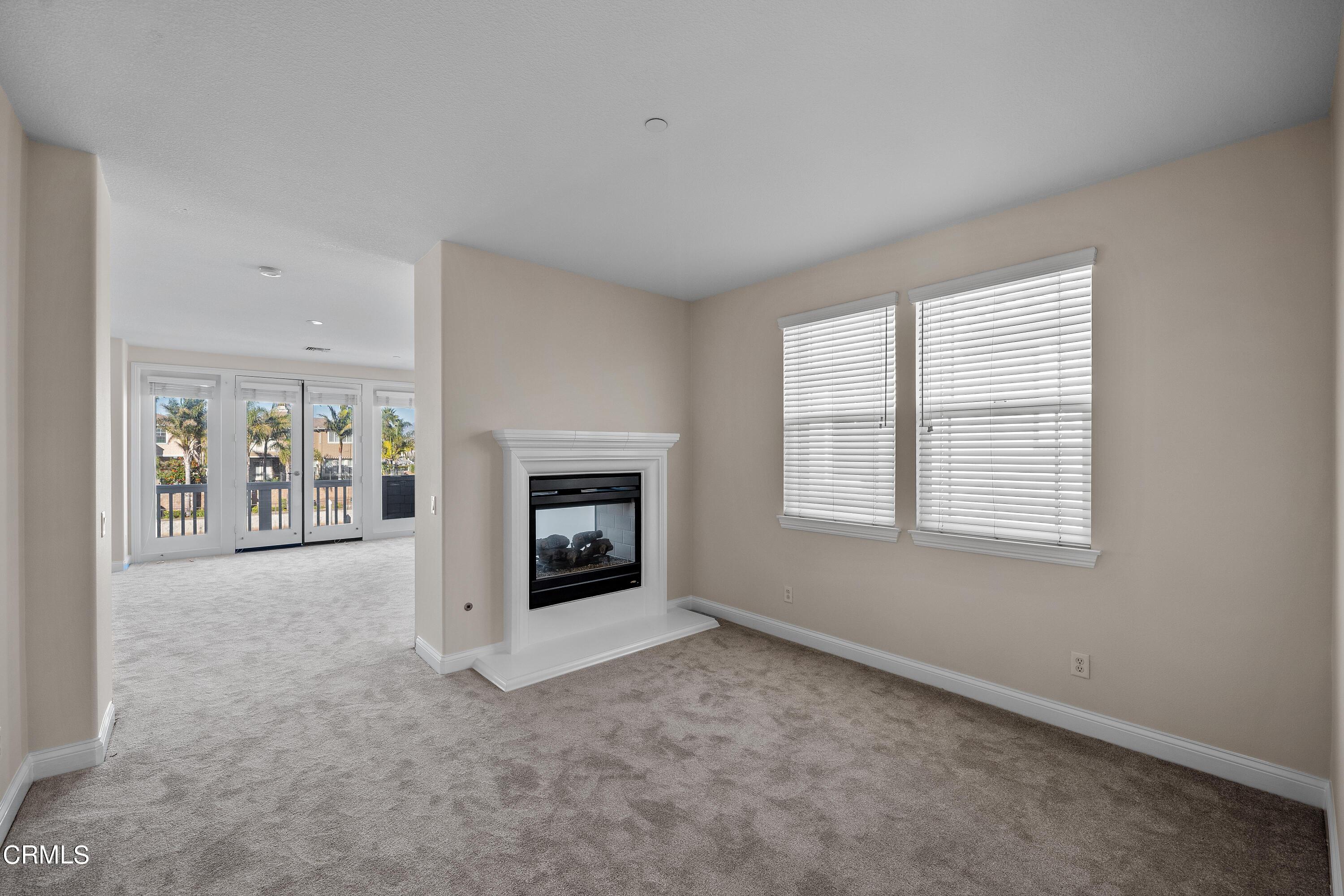 3957 West Hemlock Street Oxnard, CA 93035 - Photo 35 of 46 an empty room with windows and fireplace
