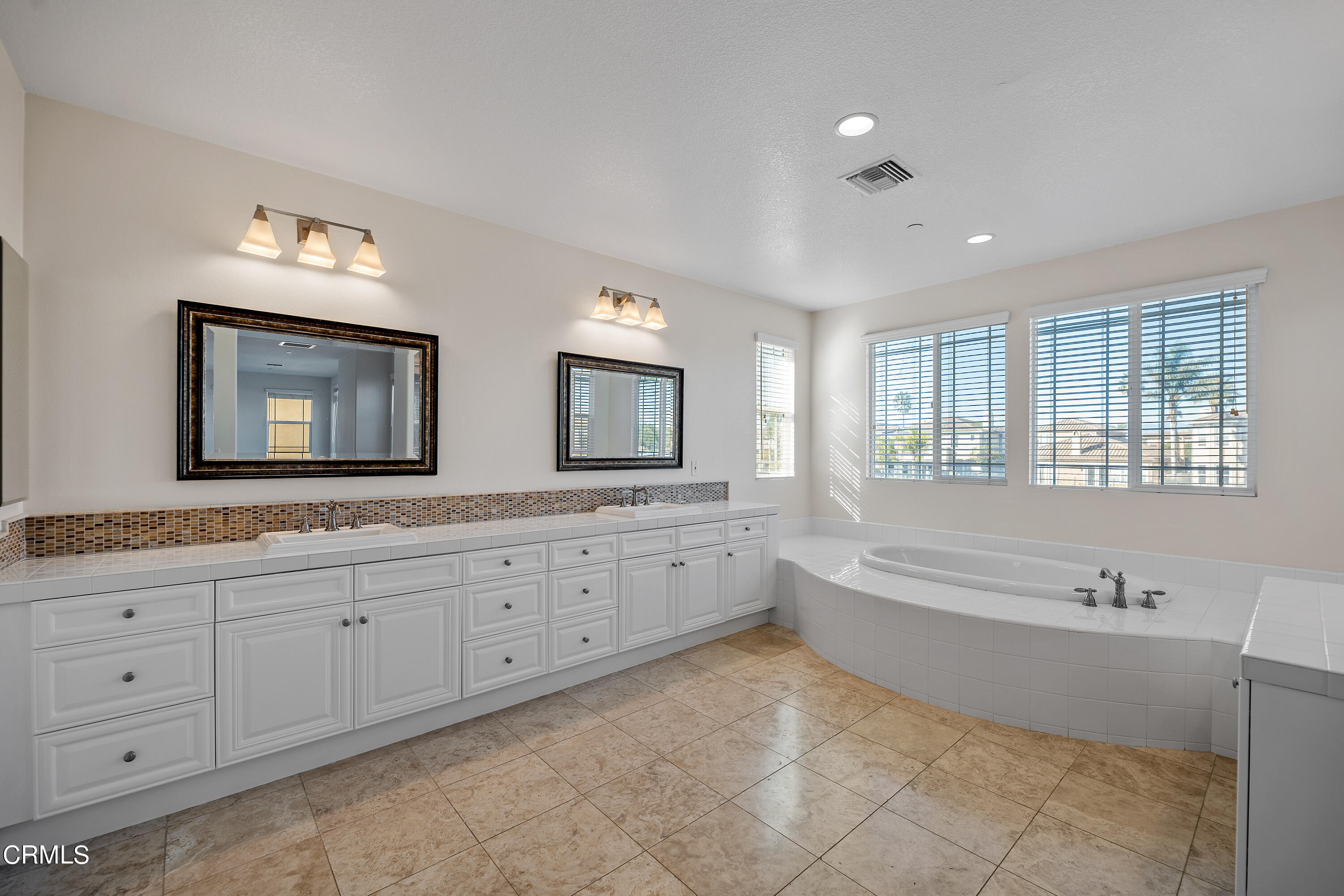 3957 West Hemlock Street Oxnard, CA 93035 - Photo 40 of 46 a spacious bathroom with double vanity a mirror a double vanity sinks and a bathtub