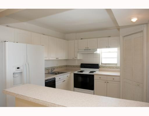 9273 Collins Avenue, Unit 1109 Surfside, FL 33154 - Photo 5 of 8 a kitchen with a sink cabinets stainless steel appliances and a window