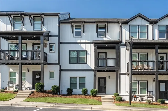 a front view of a residential apartment building with a yard