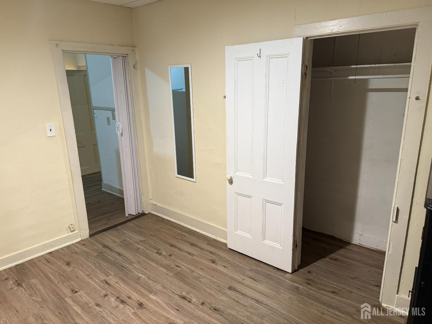 69 West Somerset Street, Unit D Raritan, NJ 08869 - Photo 9 of 12 an empty room with wooden floor and closet