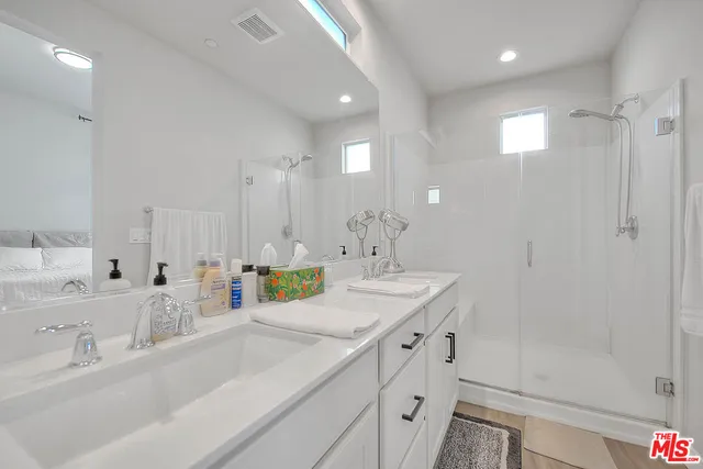 a bathroom with a sink double vanity and shower