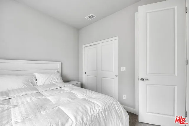 a bedroom with a bed and a closet