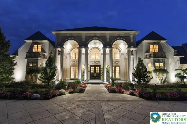a living room with furniture a fireplace and a chandelier