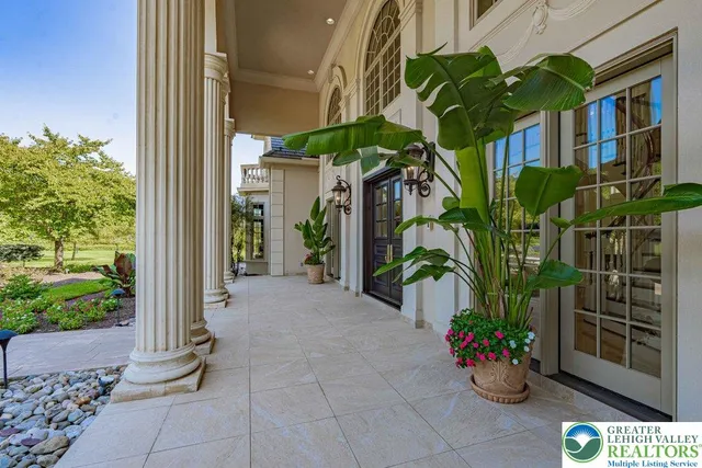 a spacious bathroom with a granite countertop sink a mirror and shower