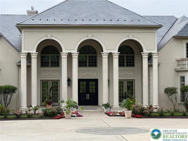 a front view of a building with potted plants