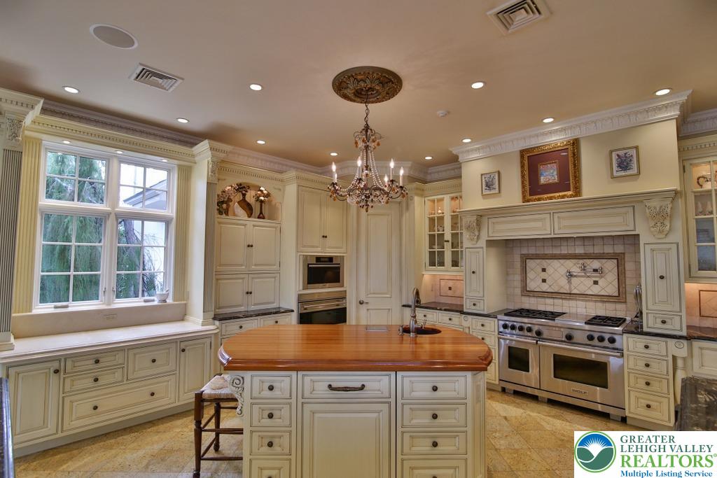 5044 Vera Cruz Road Center Valley, PA 18034 - Photo 23 of 100 a kitchen with kitchen island granite countertop a stove a sink and a refrigerator
