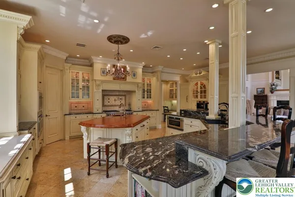 a bathroom with a granite countertop tub sink and mirror