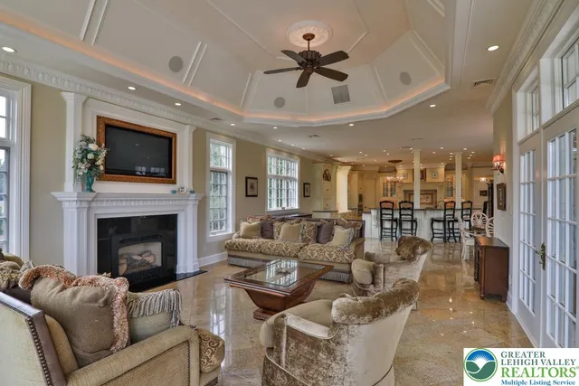 a living room with furniture and a chandelier