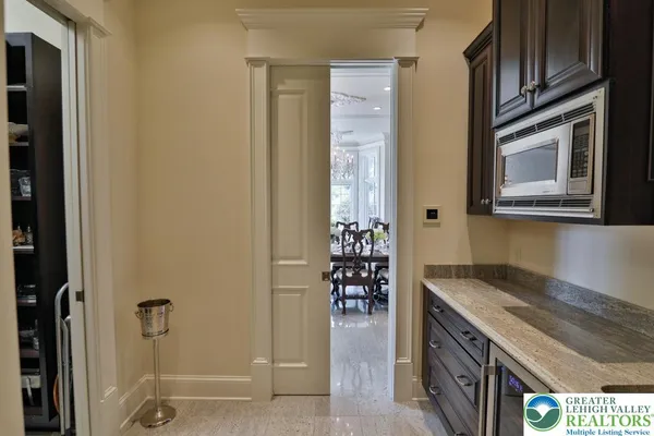 a bathroom with a granite countertop toilet sink and mirror