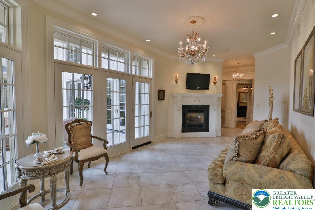 5044 Vera Cruz Road Center Valley, PA 18034 - Photo 31 of 100 a living room with furniture a fireplace and a chandelier
