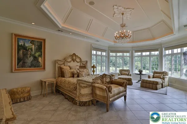 a kitchen with a stove a counter space a sink and living room view