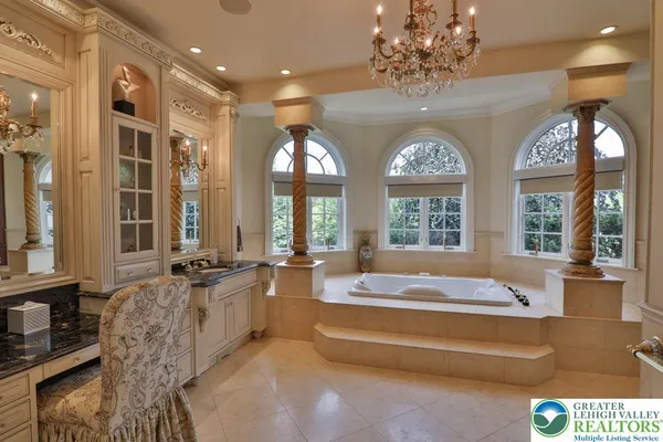 a dining room with furniture a chandelier and kitchen view