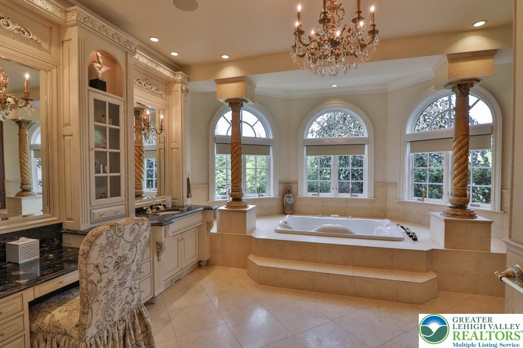 5044 Vera Cruz Road Center Valley, PA 18034 - Photo 34 of 100 a spacious bathroom with double vanity windows and a chandelier
