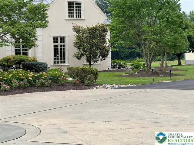an aerial view of a house with a garden and swimming pool