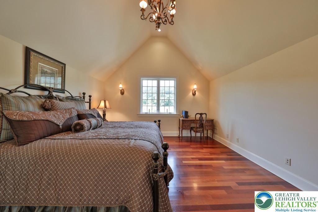 5044 Vera Cruz Road Center Valley, PA 18034 - Photo 44 of 100 a bedroom with a bed and a chandelier