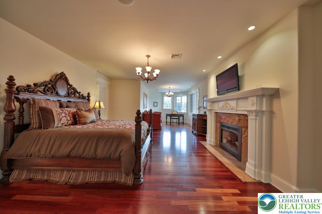 5044 Vera Cruz Road Center Valley, PA 18034 - Photo 50 of 100 a spacious bedroom with bed and a fireplace