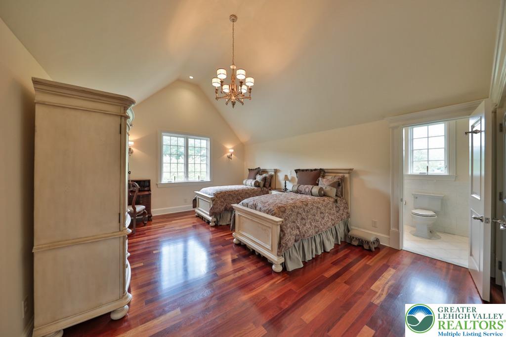 5044 Vera Cruz Road Center Valley, PA 18034 - Photo 52 of 100 a spacious bedroom with a bed and wooden floor