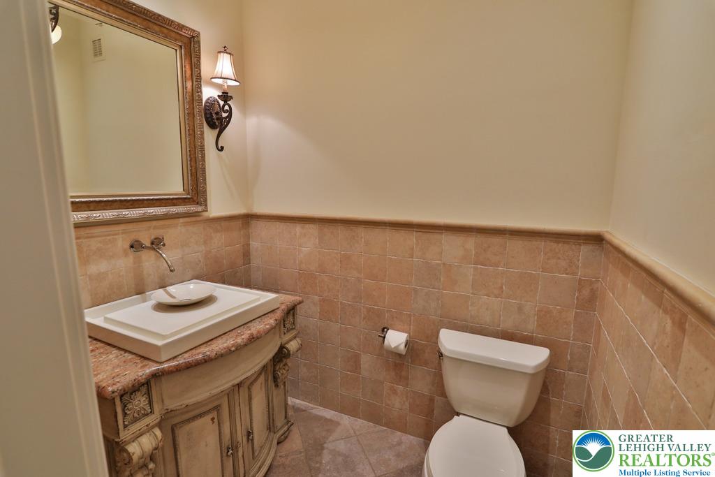 5044 Vera Cruz Road Center Valley, PA 18034 - Photo 64 of 100 a bathroom with a toilet a sink and mirror