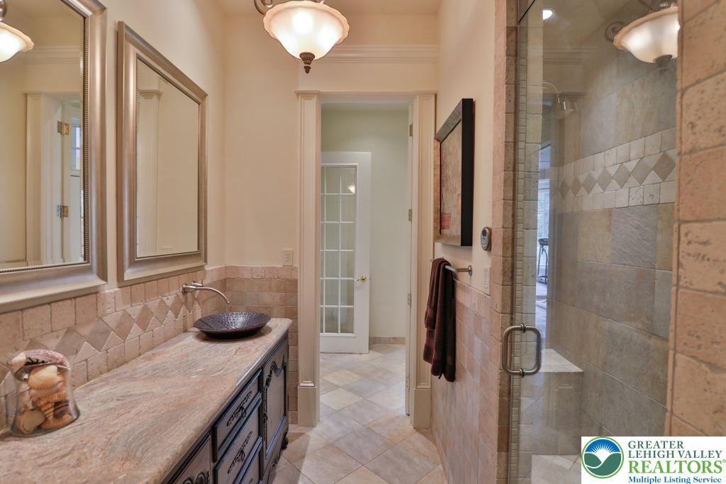 5044 Vera Cruz Road Center Valley, PA 18034 - Photo 72 of 100 a bathroom with a granite countertop sink and a mirror