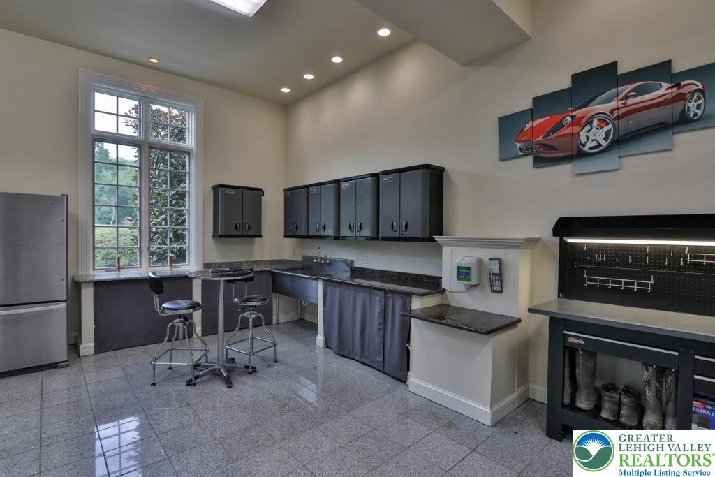 5044 Vera Cruz Road Center Valley, PA 18034 - Photo 75 of 100 a kitchen with stainless steel appliances granite countertop a stove top oven a sink dishwasher and cabinets with wooden floor